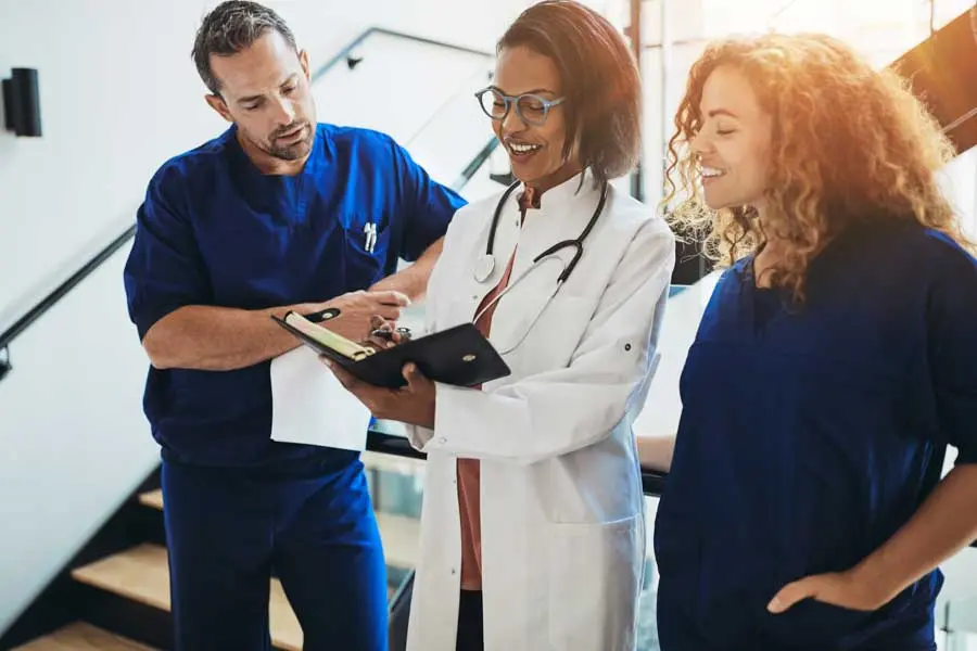 doctors discussing paperwork together in a hospital