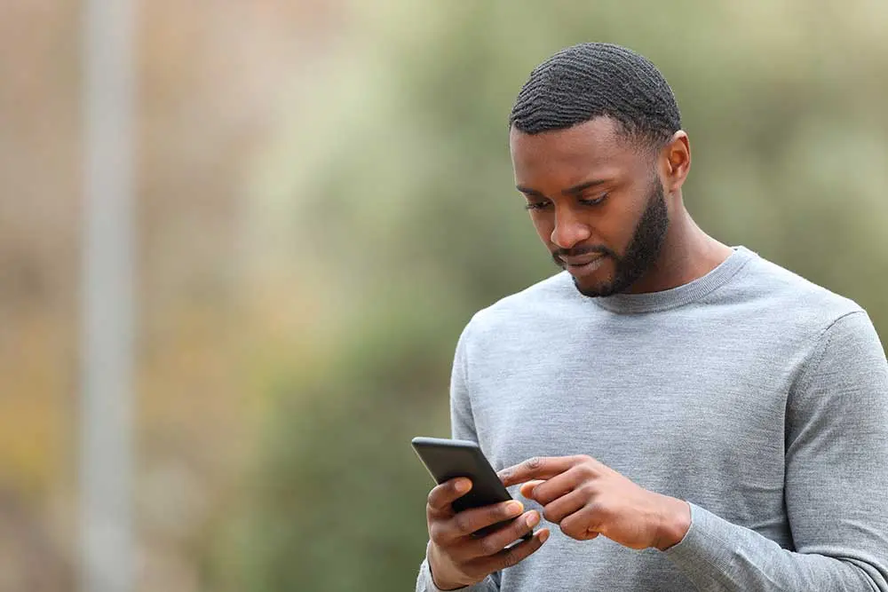 man using his phone to learn what to expect when contacting us