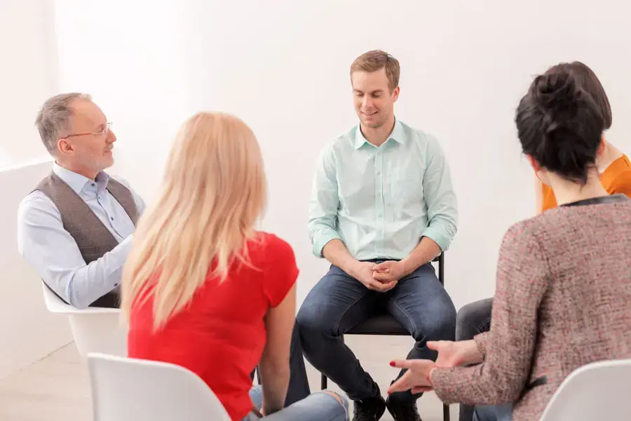 what-we-treat-addiction-treatment Cheerful group is talking on therapy session